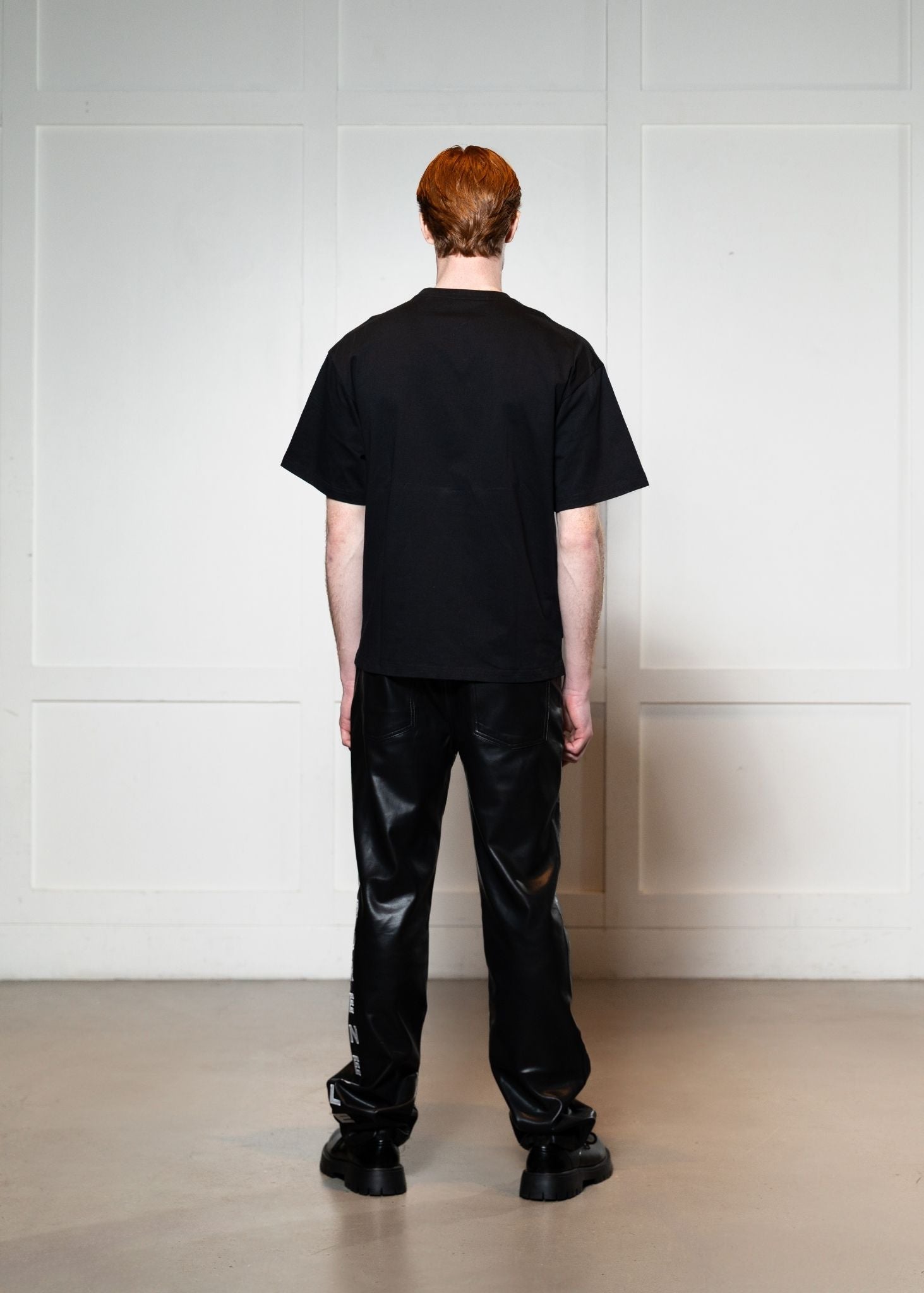 Laurenelle black vegan leather pocket tee back view. Sleek and stylish casual wear.