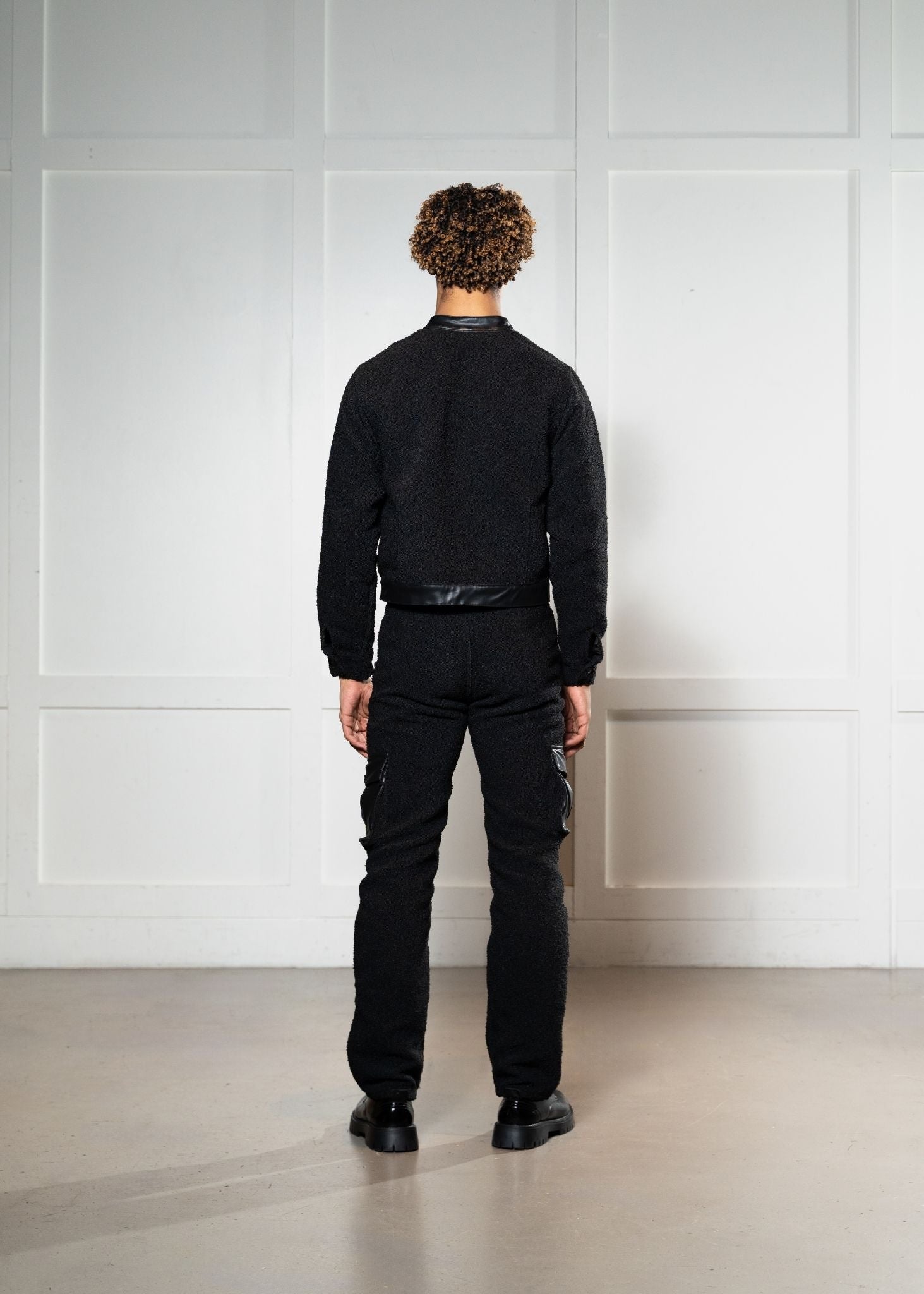 Laurenelle boucle and vegan leather jacket and pants set back view. Stylish and elegant contemporary outfit.