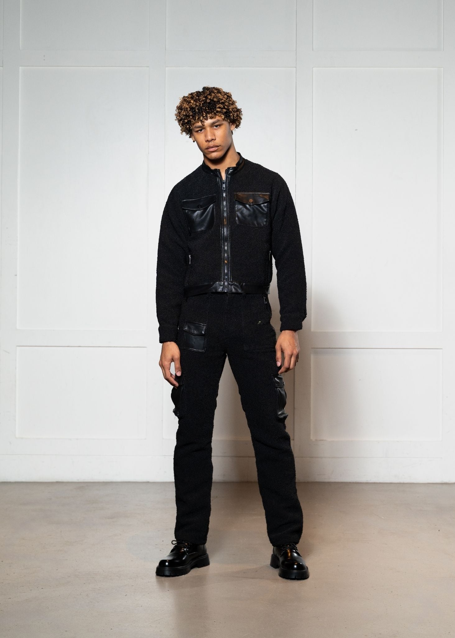 Laurenelle boucle and vegan leather jacket and pants set front view. Chic and sophisticated modern ensemble.