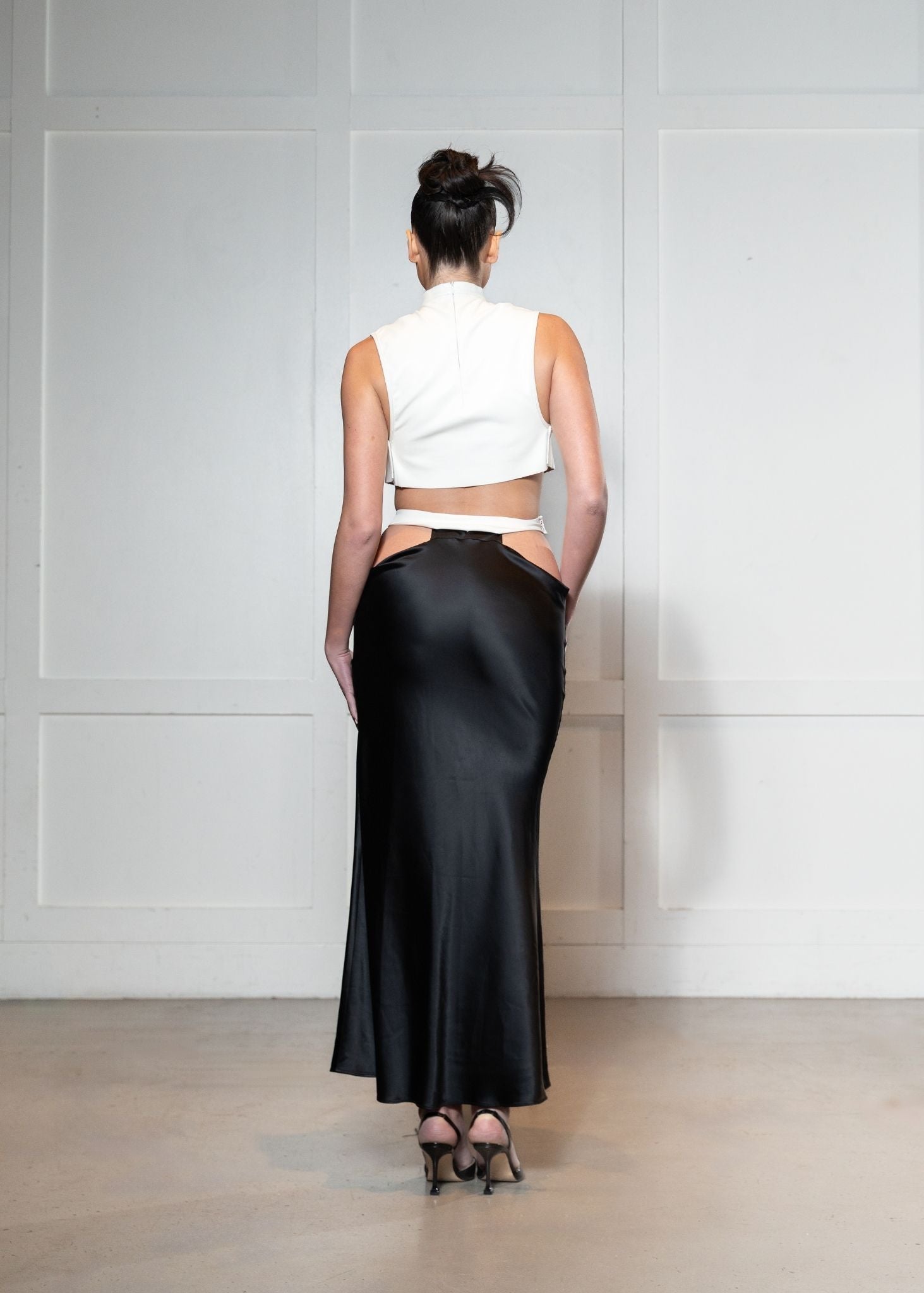 Laurenelle denim crop and black satin cutout skirt set back view. Modern and elegant fashion statement.