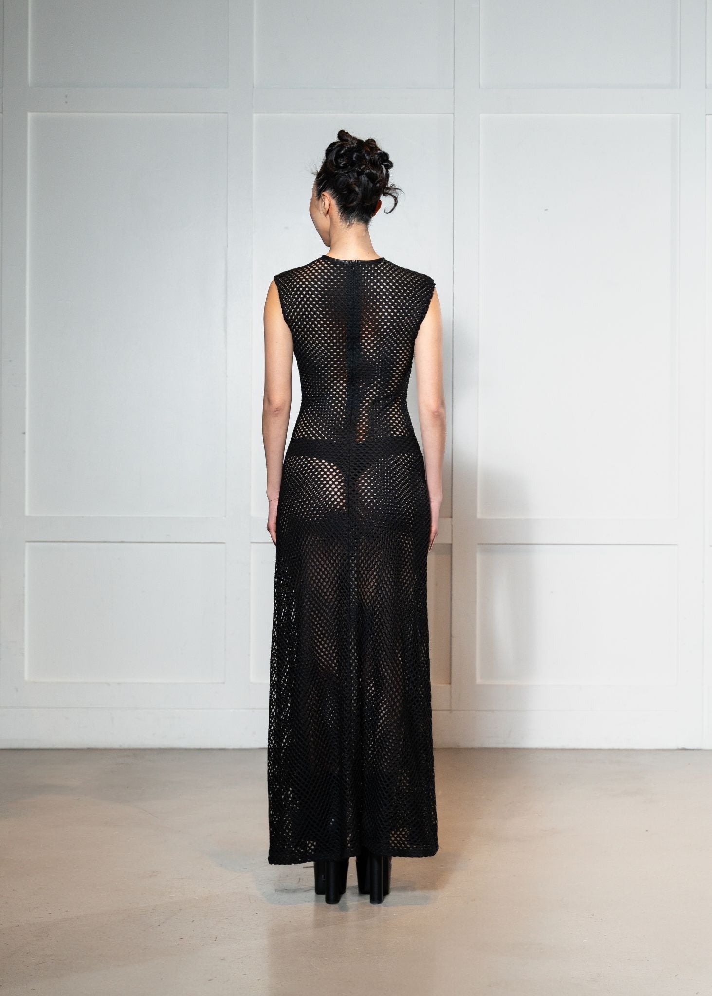 Laurenelle mesh and faux leather dress back view. Sleek and edgy modern design.