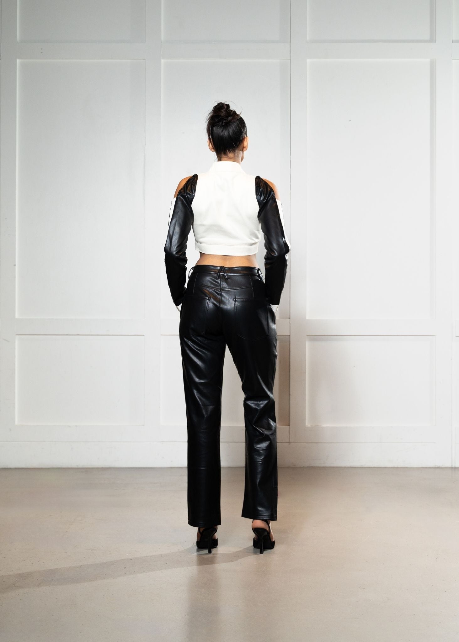 Laurenelle mesh and vegan leather pants back view. Edgy and modern fashion statement.