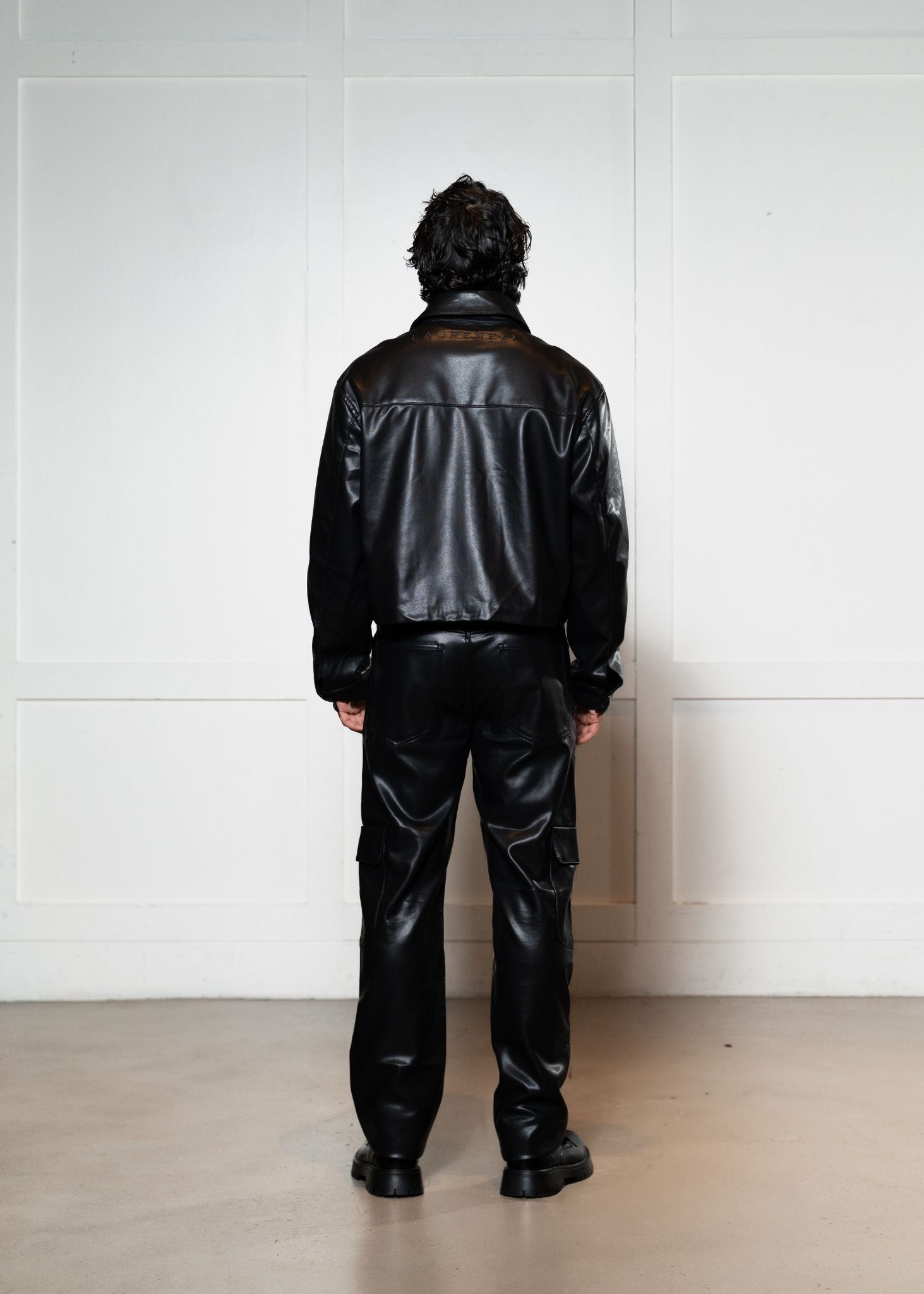 Laurenelle vegan leather two-piece set back view. Sleek and stylish contemporary design.