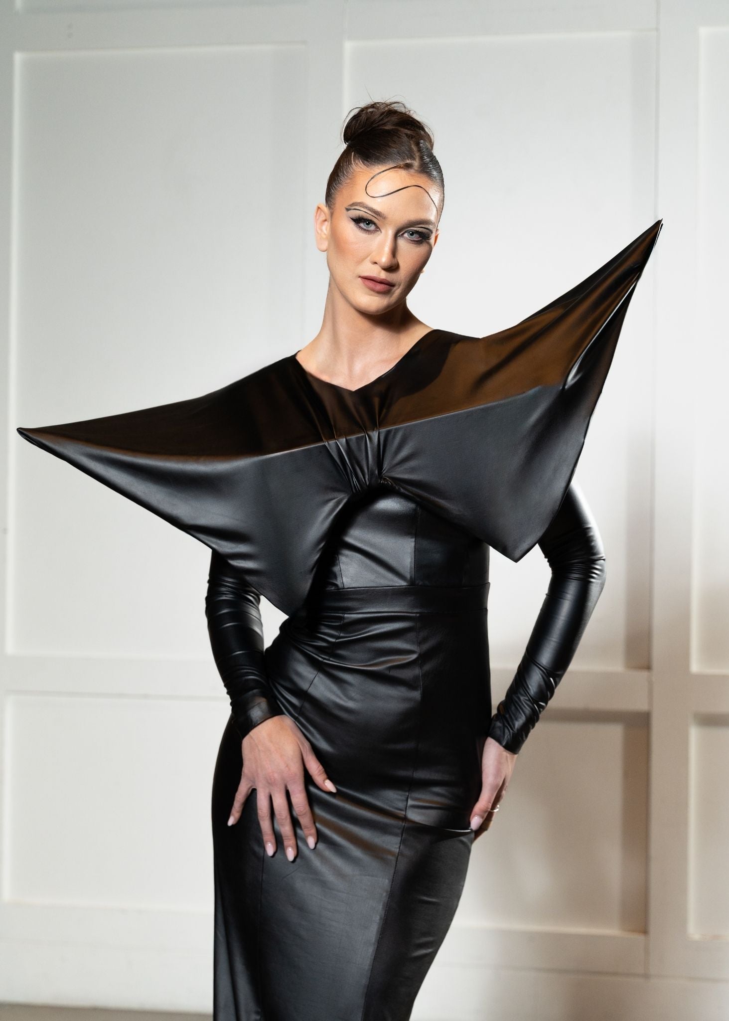 Laurenelle well-appointed leatherette statement dress cropped front view. Sleek and modern design detail.