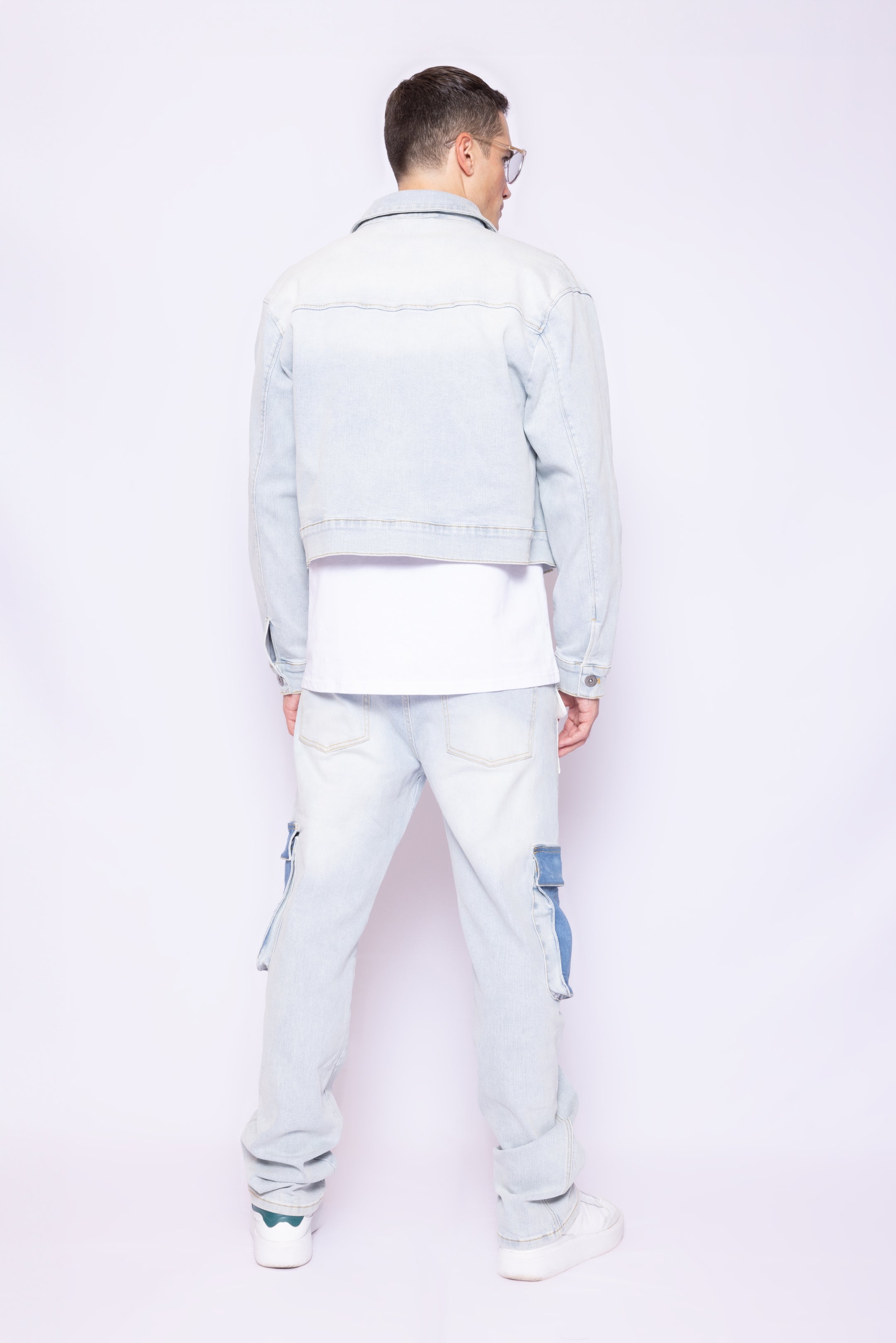 Back view of Laurenelle men’s crop denim jacket featuring a boxy fit and clean, structured hemline.