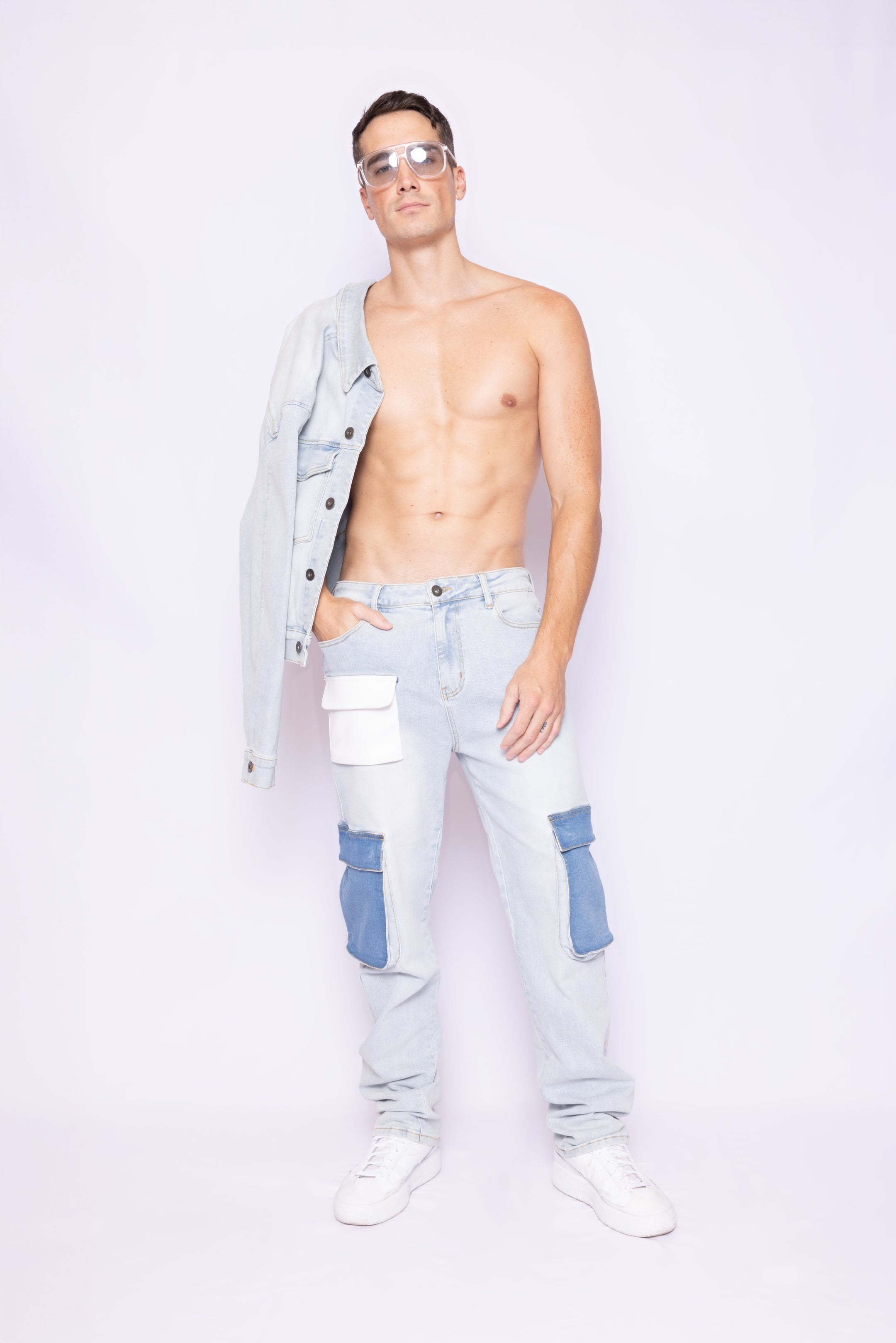 Full front view of Laurenelle men’s denim pant featuring vegan leather pocket, cargo pockets, and printed logo on right leg.