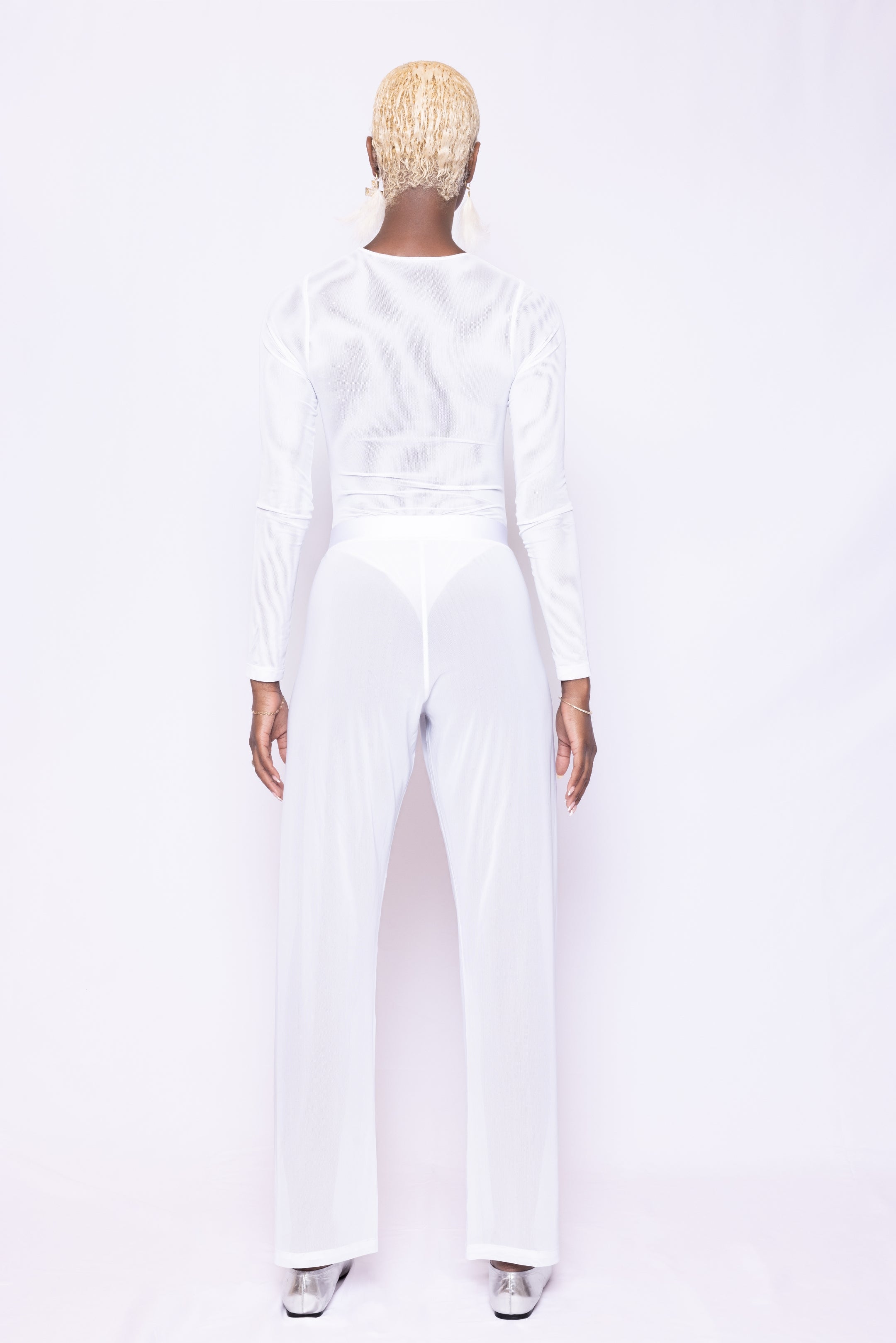 Back view of Laurenelle white mesh bodysuit showcasing a center back zipper and high-leg cut design.