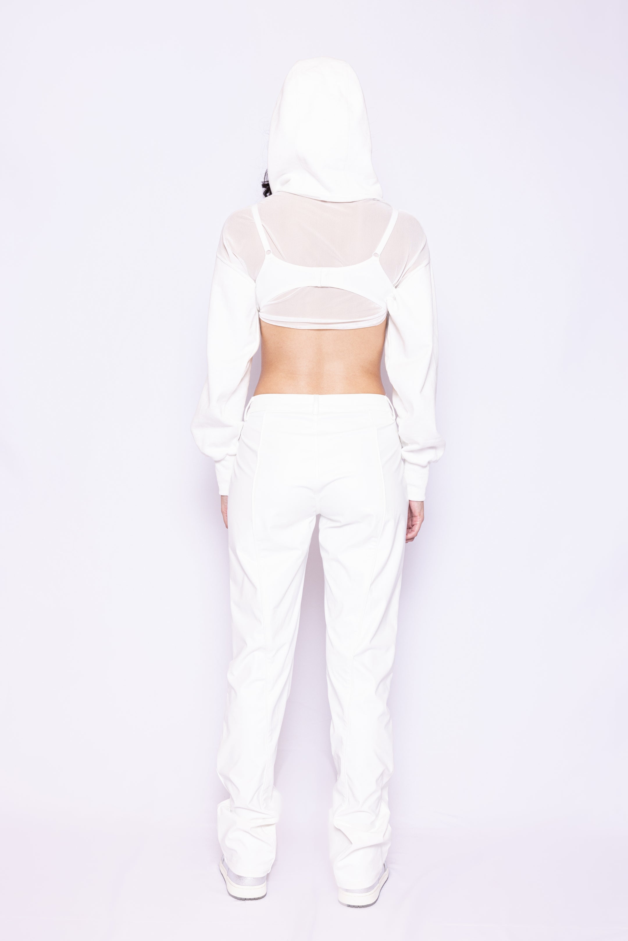 Back view of Laurenelle women’s white mesh long sleeve hoodie showcasing the rubber logo patch and French Terry hood.
