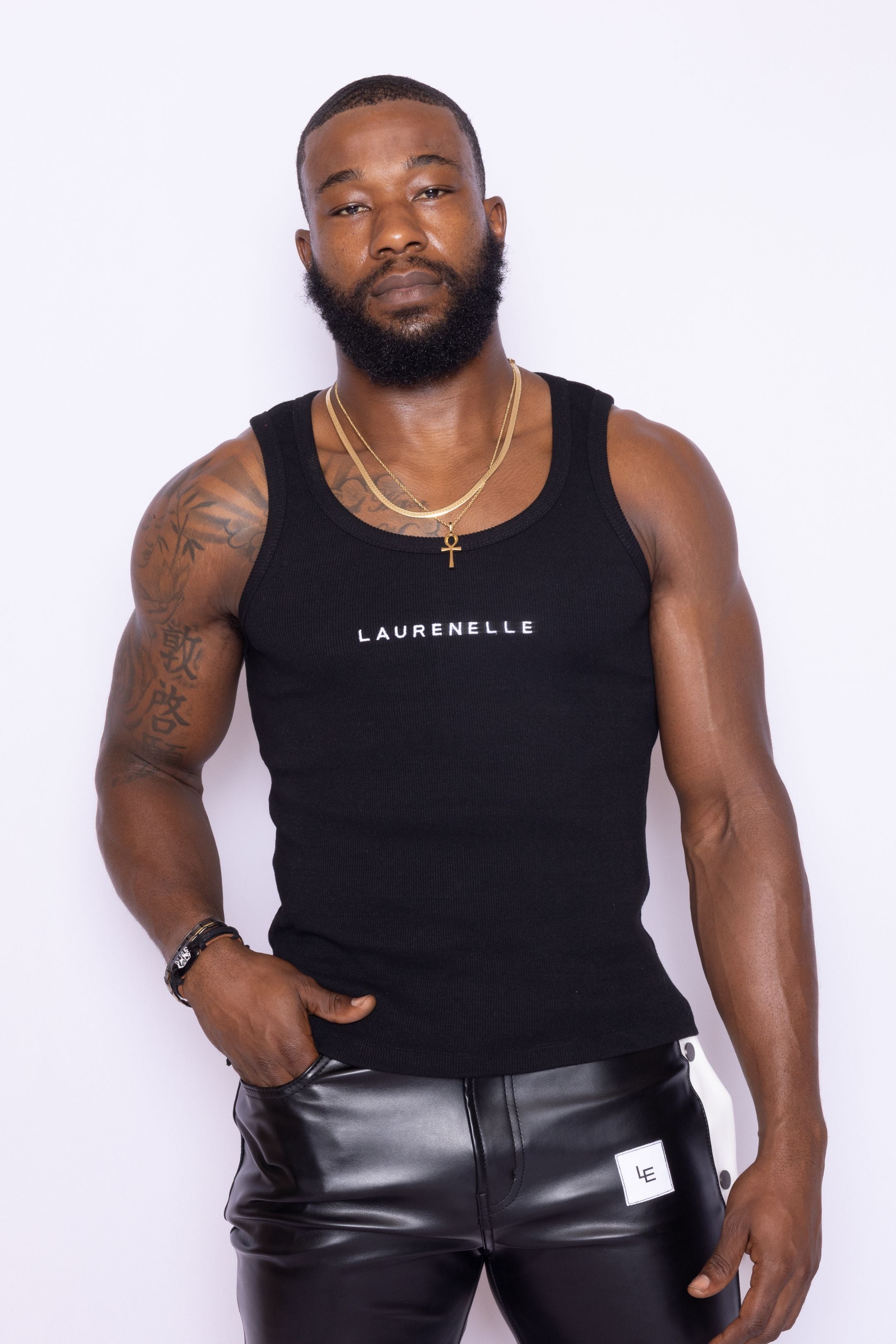 Front view of Laurenelle unisex black rib knit tank with soft fabric and embroidered logo on the front.