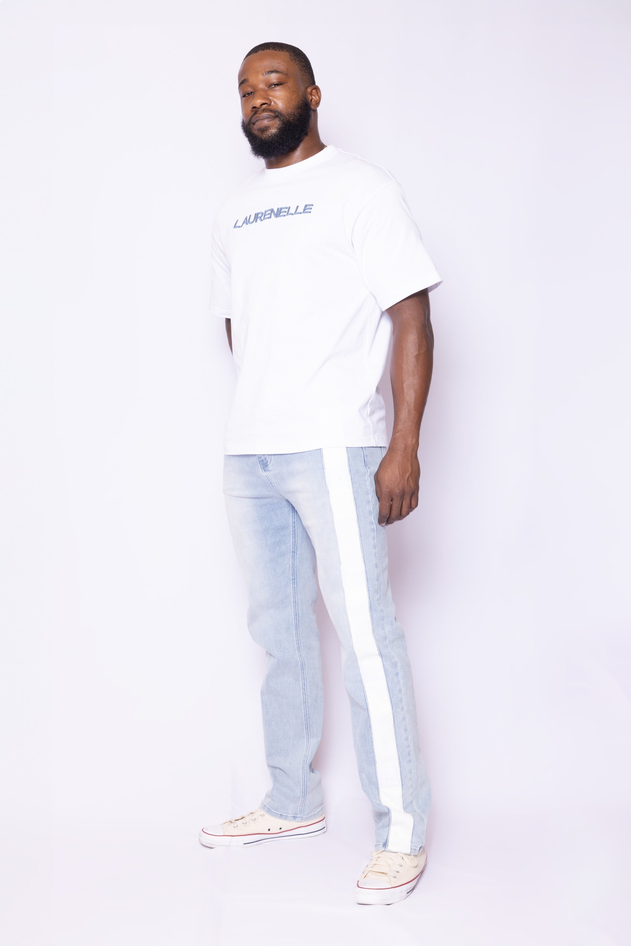 Front view of Laurenelle men’s light wash denim vegan leather side strip jean featuring rubber logo patch and straight leg design.