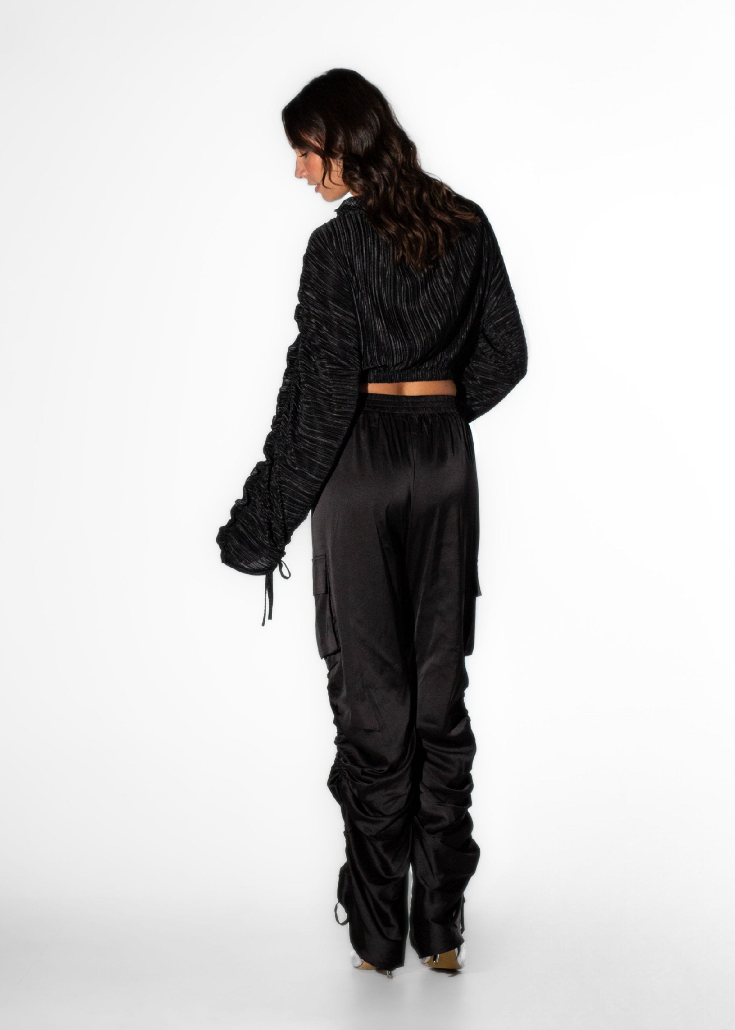 Back view of Laurenelle women’s black draw-string cargo pant highlighting ruched-leg details and a relaxed fit.