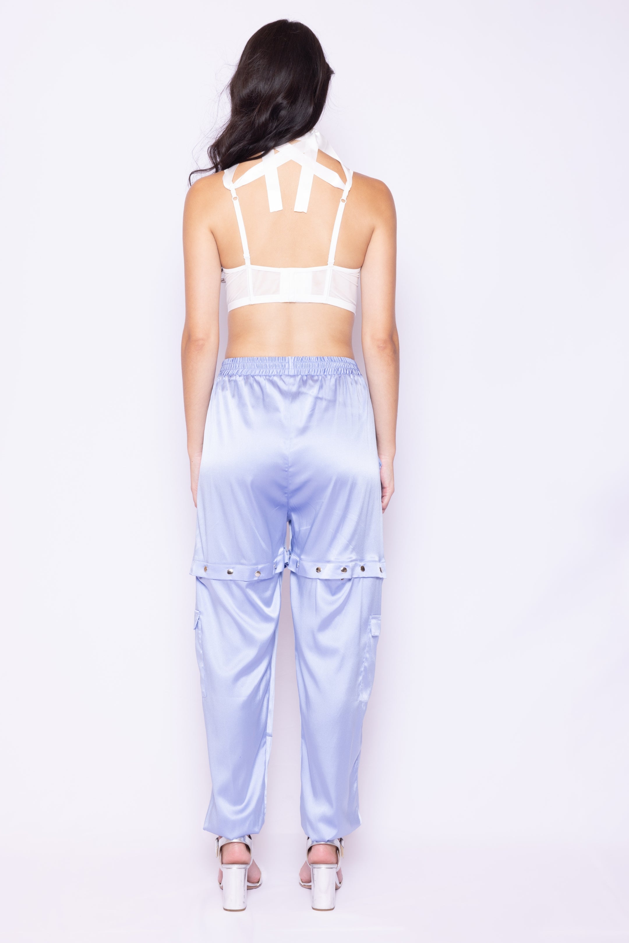 Back view of Laurenelle women’s light blue satin pants featuring snap closures and loose fit design.