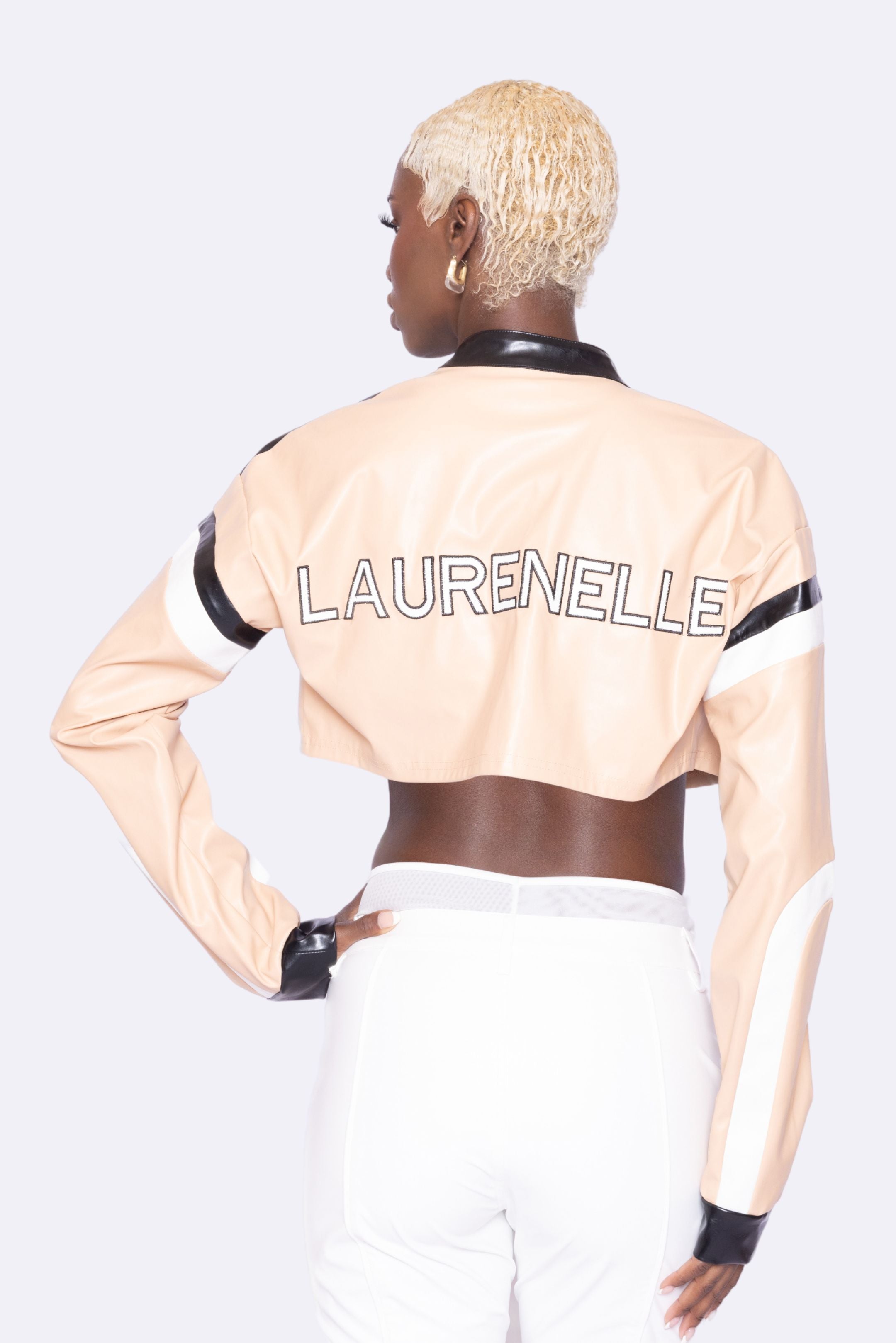 Back view of Laurenelle women’s vegan leather moto jacket featuring a signature logo patch on the back and cropped length.