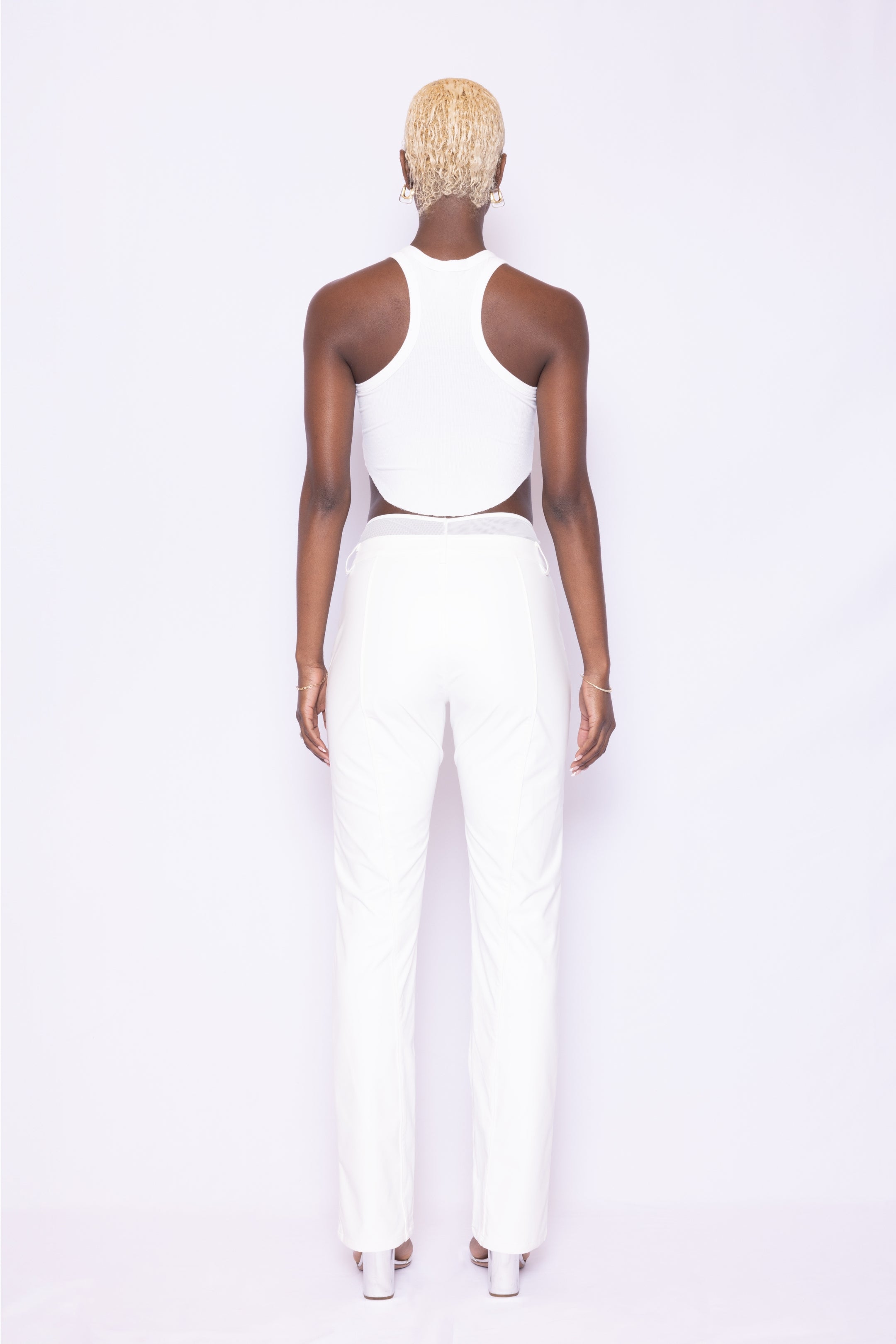 Back view of Laurenelle women’s white vegan leather pants highlighting clean piping detail and comfortable fit.