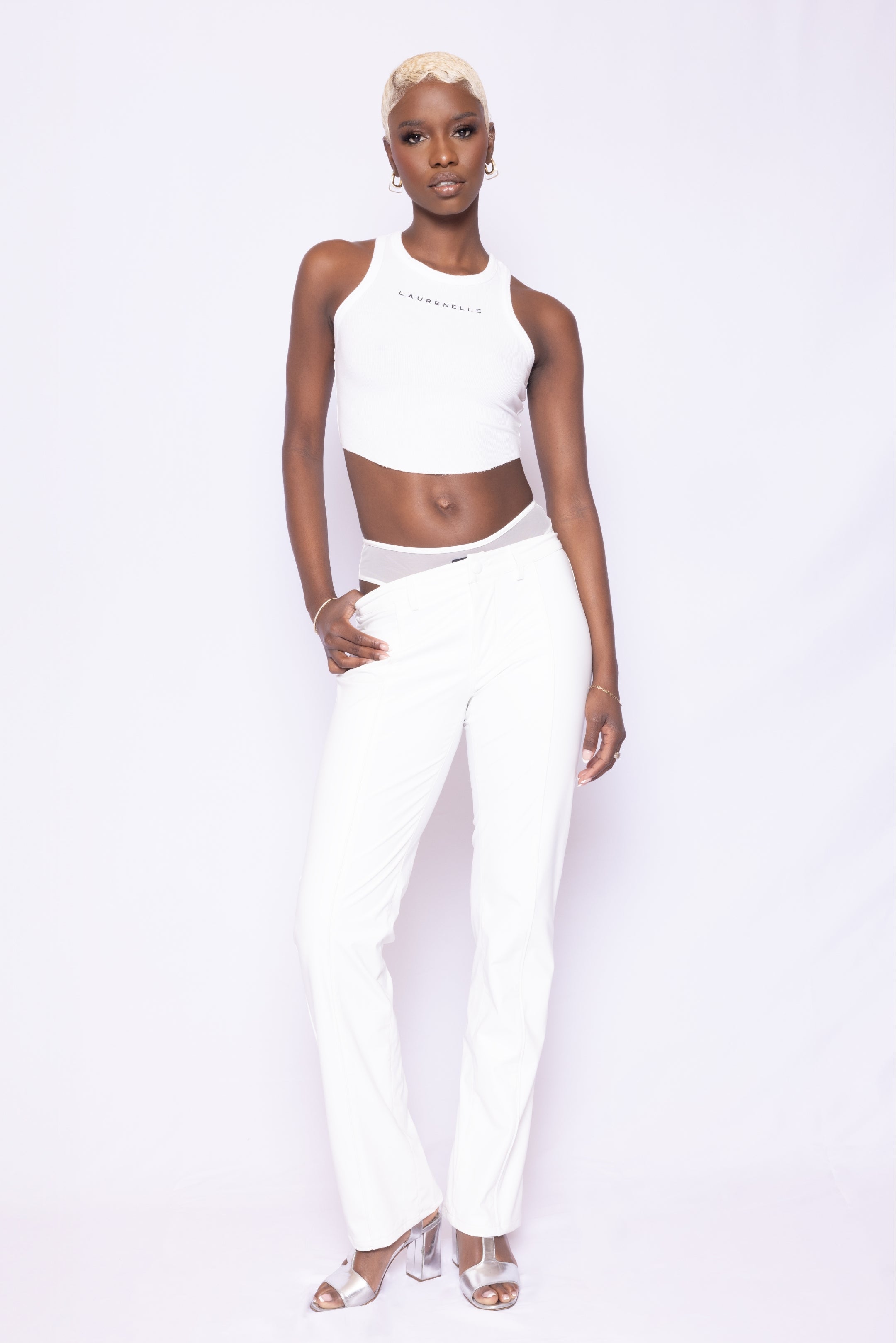 Alternate front view of Laurenelle women’s white vegan leather pants showcasing self-covered button and sleek piping detail.